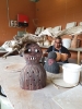 Artist Philomena Yeatman and Belonging 'hairy men' ceramic artworks at Yarrabah Art Centre, October 2019. Image. Edwina Circuitt IACA